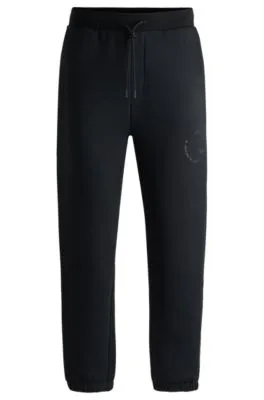 Pantalones de chándal relaxed fit con ilustración tonal